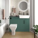 Matt green fitted furniture with brushed gold handles, taps and flush plate