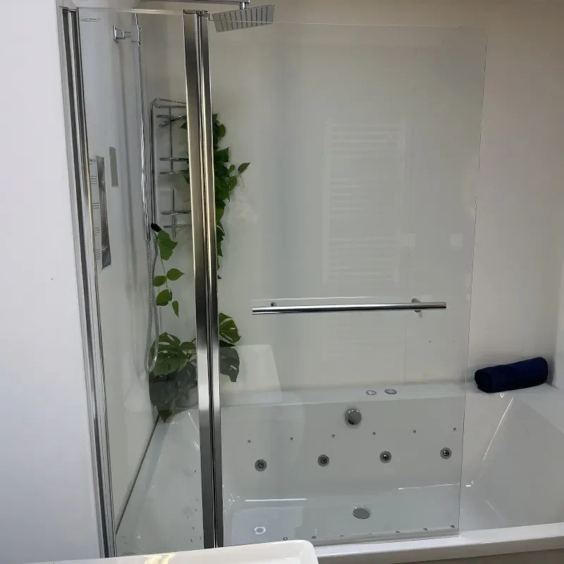 Showroom Lifestyle Image for Radiant Square Bath Shower Screen with Inline Panel & Rail